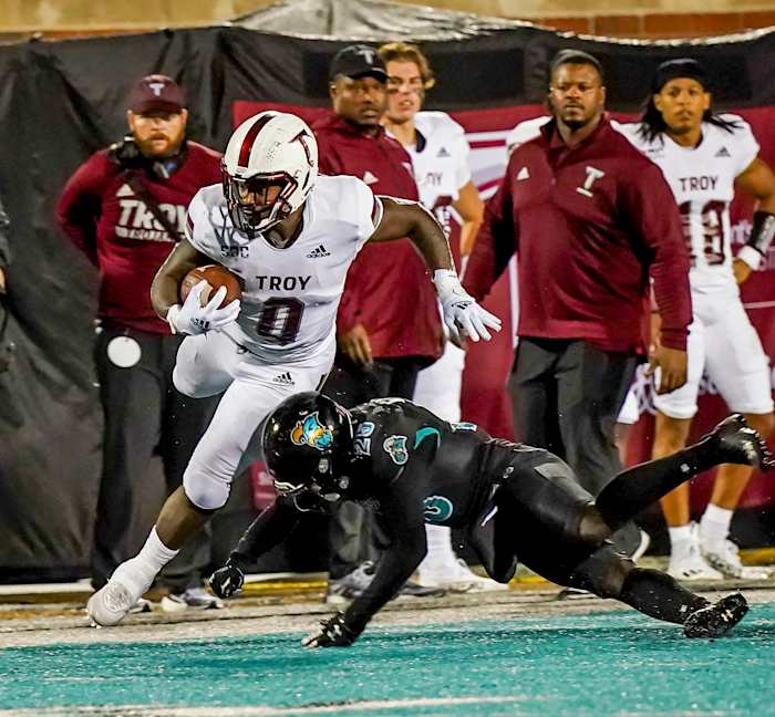 Troy Trojans running back Kimani Vidal (0) is tackled by Coastal Carolina Chanticleers linebacker Mason Shelton (20) at Brooks Stadium.